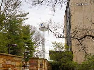 The outside entrance of Allen Hall with the WVU Water Tower in the background